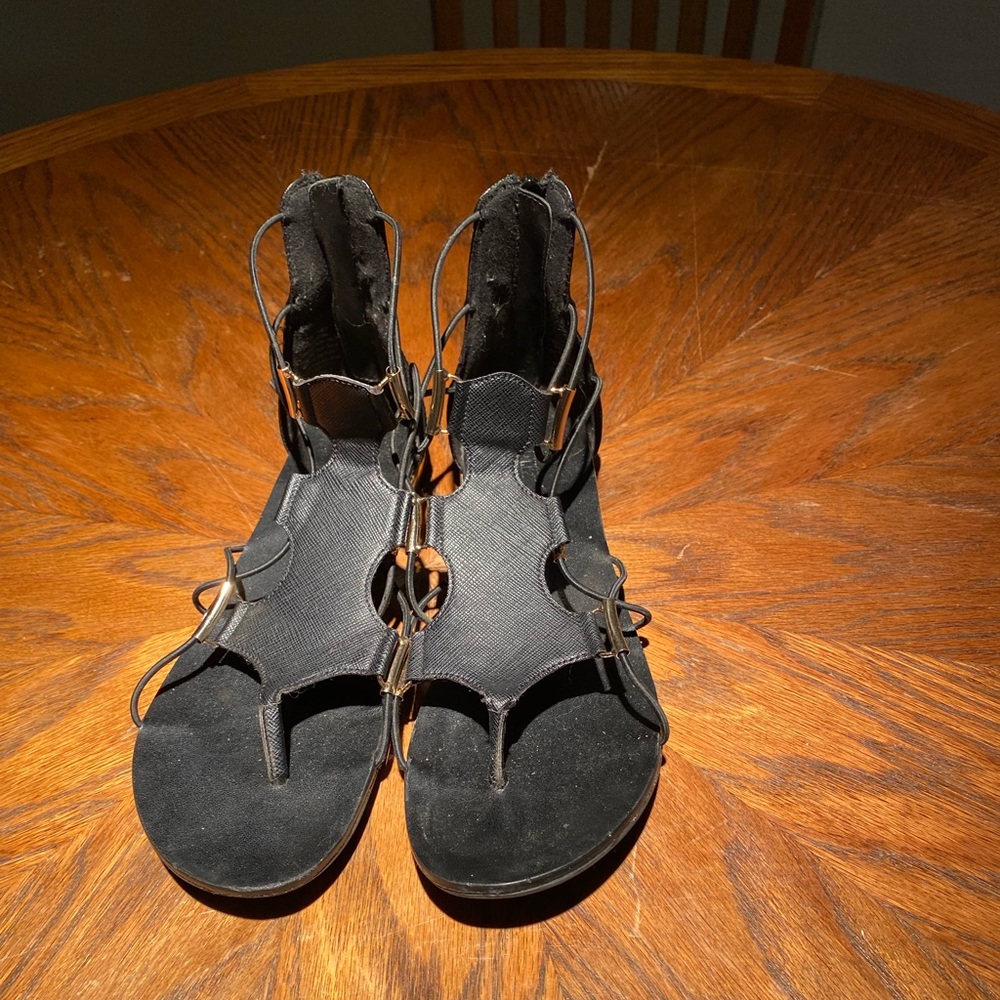 Black flat sandals with zipper up back, gold details